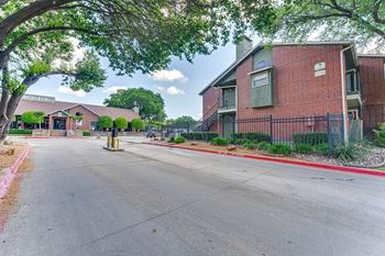 A street view of a residential area with houses and trees.
